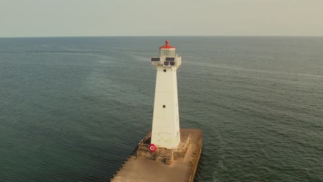 Drone-shot-fly-around-of-the-small-light-houses-at-Sodus-point-New-York-vacation-spot-at-the-tip-of-land-on-the-banks-of-Lake-Ontario