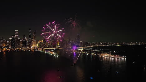 Drone-shot-of-weekly-firework-show-on-the-coast-of-Chicago,-nighttime-in-USA