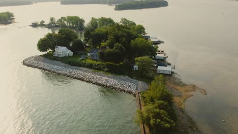 Drone-shot-of-the-small-island-and-beach-houses-at-Sodus-point-New-York-vacation-spot-at-the-tip-of-land-on-the-banks-of-Lake-Ontario