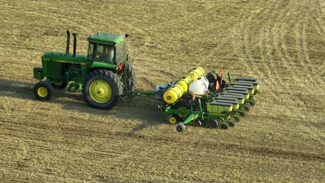 John-Deere-tractor-and-planter-sowing-no-till-corn-seed-after-grain-wheat-barley-harvest