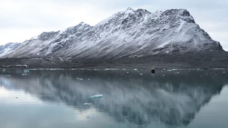 Reflections-of-a-mountain-by-a-glacier-in-the-Arctic-Sea