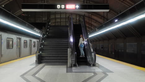 Young-lady-subway-with-escalator-in-Toronto