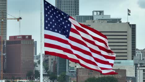 American-flag-waving-in-front-of-Omaha,-Nebraska-skyline