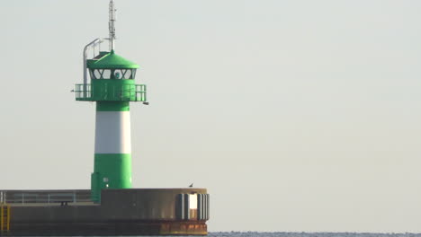 the-green-lighthouse-of-Luebeck-Travemuende-stands-at-the-entrance-of-the-harbor