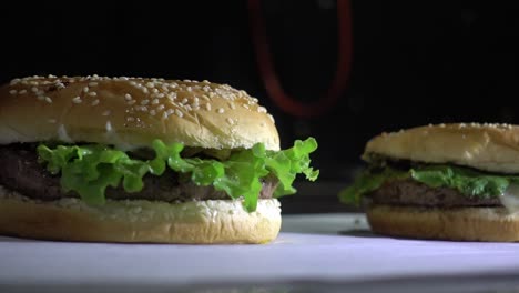 Slow-dolly-right-revealing-multiple-burgers-served-on-paper-ready-for-serving