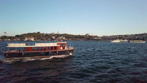 Evening,-cinematic-slow-mo,-picturesque-view-of-Sarayburnu-from-ferry-on-Golden-Horn-in-Istanbul