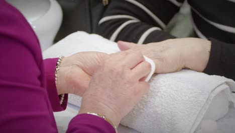 Nail-polishing-of-a-old-woman's-hand