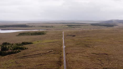 Drone-shot-of-a-single-track-road-near-a-shieling-on-the-Isle-of-Lewis