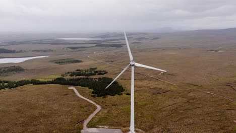 Panning-drone-shot-of-a-wind-turbine-on-the-peatland-of-the-Isle-of-Lewis