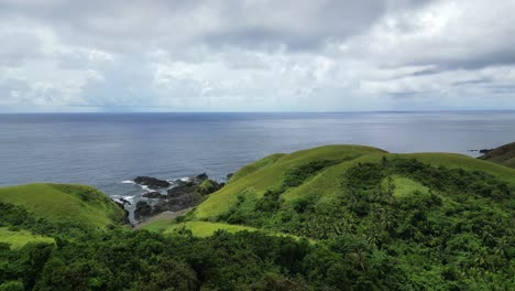 Green-Hills-And-Ocean-On-A-Cloudy-Day-In-Baras,-Catanduanes,-Philippines---aerial-drone-shot