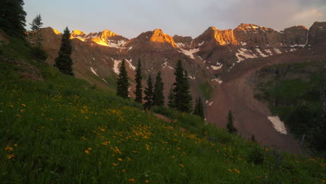 Last-Light-Mount-Sniffels-14er-peaks-wilderness-yellow-wildflowers-Upper-Blue-Lake-Colorado-summer-snow-melting-top-of-Rocky-Mountain-stunning-golden-hour-sunset-Silverton-Telluride-14er-cinematic-pan