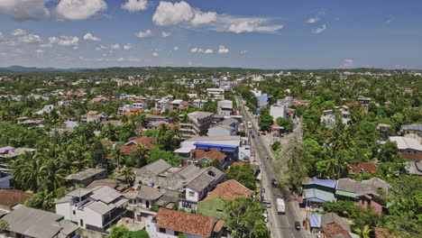Matara-Sri-Lanka-Aerial-v5-establishing-shot-drone-flyover-along-B535-highway-Nilwala-Bypass-through-Nupe-town-area-capturing-local-townscape-on-a-sunny-day---Shot-with-Mavic-3-Cine---April-2023