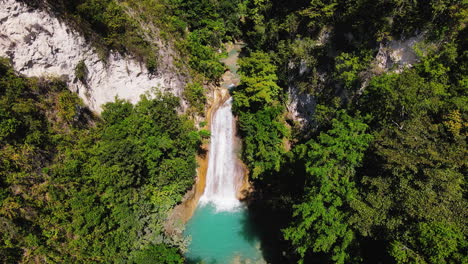 Aerial-View-Of-Waterfall-In-The-Midst-Of-Wilderness-In-Summer
