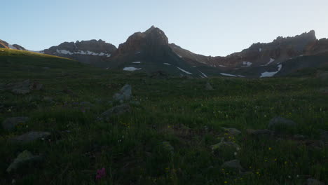 Cinematic-pan-right-breeze-colorful-wildflower-Colombine-Colorado-last-Dusk-sunset-golden-hour-light-Ice-Lake-Basin-Silverton-Telluride-Ouray-Trailhead-top-of-peak-Rocky-Mountains-landscape-slow