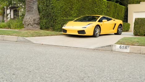 Sports-Car-Bottoms-out-Pulling-out-of-Driveway-in-Beverly-Hills,-California
