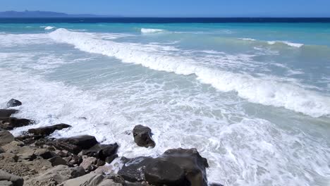 Azure-Mediterranean-Drama:-White-Foam-on-Rocky-Shore,-Sea-Waves-Splashing-Against-Cliffs---Nature's-Breathtaking-Coastal-Spectacle