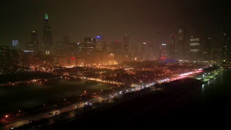 Chicago-USA,-Aerial-View-of-Traffic-and-Central-Buildings-on-Cold-Winter-Night,-Cars-and-Buildings-in-Lights