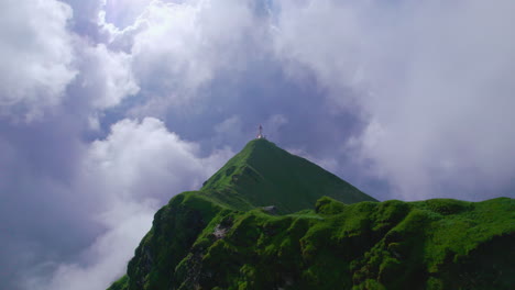 Nepal-Jesus-Christ-Cross-Christian-in-Green-Hills-Clouds,-adventurous,-blue-sky,-Buddhist-flags,-hills,-landscape,-travel,-tourism,-drone-shot-4K