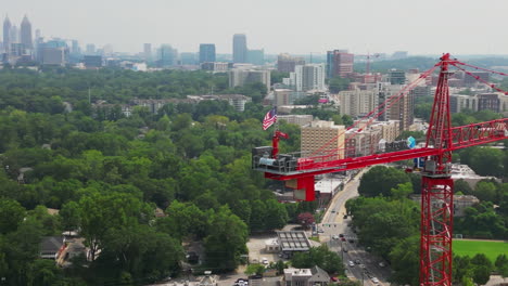 Aerial-view-of-American-flag-fluttering-in-wind-on-tall-tower-crane