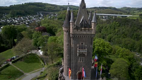 Fly-away-from-the-historical-Wilhelmsturm-in-Dillenburg-town-in-may,-recorded-by-a-drone
