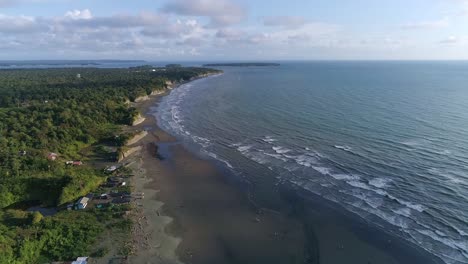 An-aerial-view-of-the-waves-crashing-on-La-Barra-beach,-a-natural-reserve-in-the-Colombian-Pacific