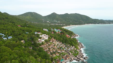 Top-view-of-South-of-Koh-Tao-coastline:-cottages,-houses,-hotels-are-built-along-the-shore,-Thailand