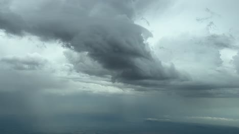 Dramatic-stormy-sky-shot-from-an-airplane-cockpit-flying-over-Mallorca-Island,-Spain,-with-rainfalls