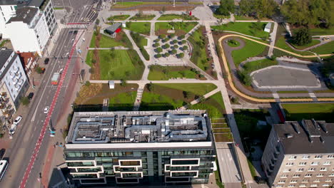 Top-Down-aerial-over-the-central-park-in-Gdynia---modern-urban-space-next-to-a-busy-street-and-modern-office-buildings