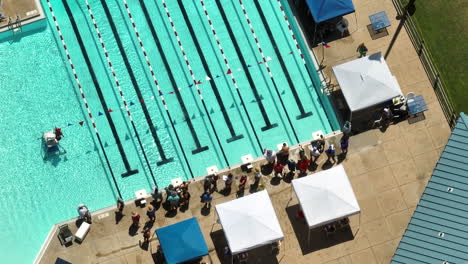 Open-air-swimming-tournament-with-gathered-audience-during-sunny-summer-day