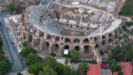 Aerial-view-orbiting-Side-amphitheatre-remains-of-the-archway-stone-walls-landmark-in-Turkish-old-town