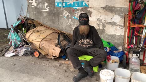 A-homeless-man-resides-on-the-sidewalk-adjacent-to-the-building