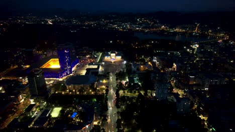 Tirana's-Nocturnal-Splendor:-Capital-City-at-Night,-Illuminated-Buildings,-and-Boulevard-Ablaze-with-Vibrant-Lights---Urban-Elegance