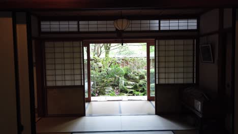 View-Inside-of-Traditional-Japanese-Wood-House-With-Tatami-Room-and-Green-Garden