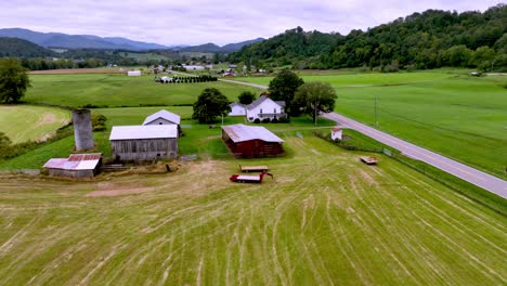 aerial-push-over-farmhouse-along-roadway-near-mountain-city-tennessee