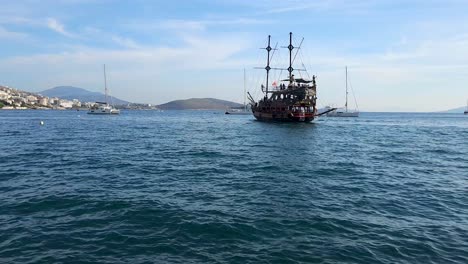 Tour-Ship-Full-of-Tourists-Sailing-in-the-Bay-Harbor,-Visiting-Attraction-Destinations-in-the-Coastal-City,-Exploring-Saranda-Wonders