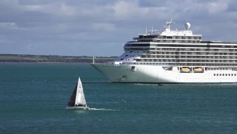 Sail-boat-passing-anchored-Cruise-Liner-at-Dunmore-East-Waterford-Ireland