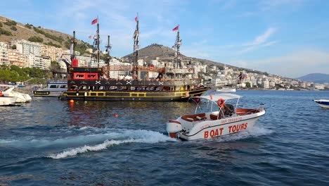 Boat-Tour-Sets-Sail,-Leaving-the-Harbor-of-Saranda,-Sailing-Adventure-Begins-on-a-Spectacular-Summer-Vacation-Destination-by-the-Sea