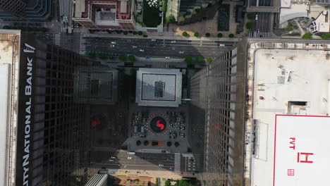 City-national-bank-and-streets-of-Downtown-Los-Angeles,-USA---top-down,-drone-shot