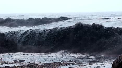 Black-wave-breaking-in-the-ocean-with-river-debris