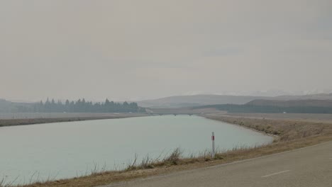 Wildfire-smoke-causing-hazy-conditions-at-bridge-over-hydro-canal-in-the-Mackenzie,-NZ