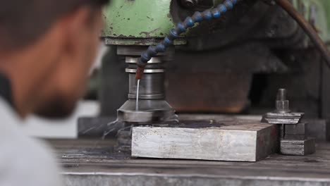 Close-up-scene,-grinding-of-iron-parts-with-VMC-grinding-machine