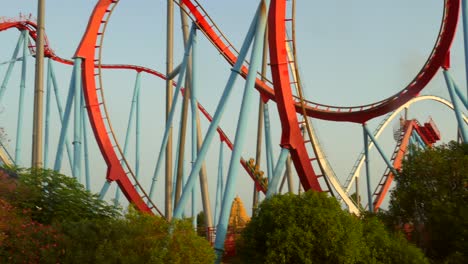 Shot-of-dragon-khan-rollercoaster-moving-in-Port-Aventura-amusement-park-in-Salou,-Spain