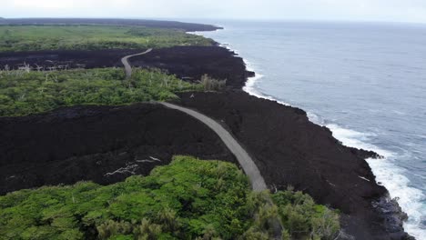 Two-2018-lava-flows-that-reached-the-ocean-with-a-road-over-them-and-surviving-forest-surrounding