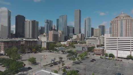 An-aerial-establishing-shot-gradually-zooming-in-on-downtown-Houston-from-the-southeast-under-blue-skies-and-a-few-clouds