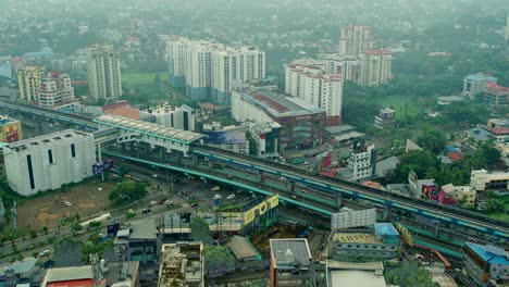 Kochi-city-aerial-view-Edappally-Junction-is-an-intersection-at-Edappally,-Ernakulam-city-aerial-view_-Edappally-Signal-Junction_Overhead-rail-track-of-Kochi-Metro-train-service