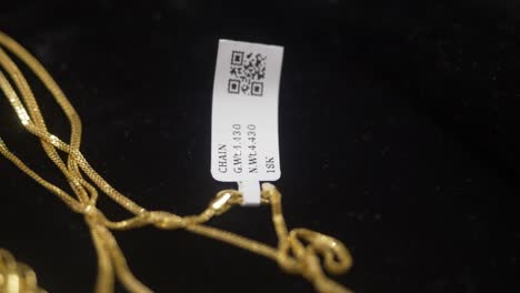 Hallmarked-18k-gold-with-barcode-tag,-Closeup
