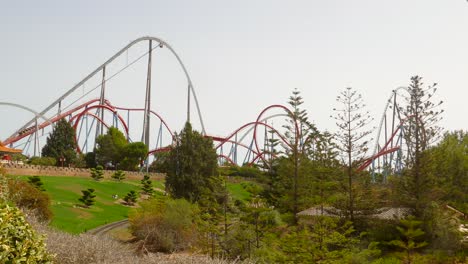Pan-shot-of-famous-dragon-khan-rollercoaster-at-Port-Aventura-Amusement-Park-in-Salou,-Spain