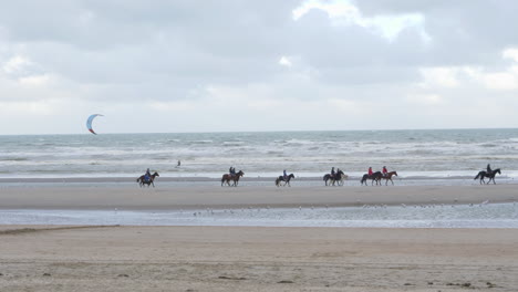 People-Kite-Surfing-And-Horseback-Riding-On-the-Beach