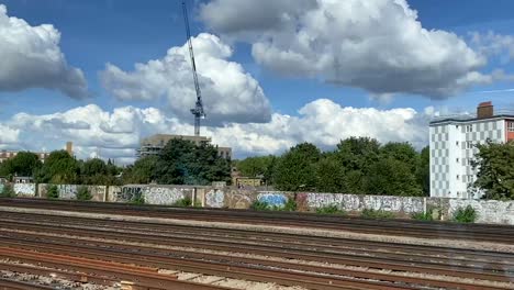 Scenery-from-the-window-of-a-train-traveling-outside-central-London,-UK