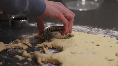 Slow-motion-shot-of-a-baker-using-a-cookie-cutter-on-a-scone-mixture